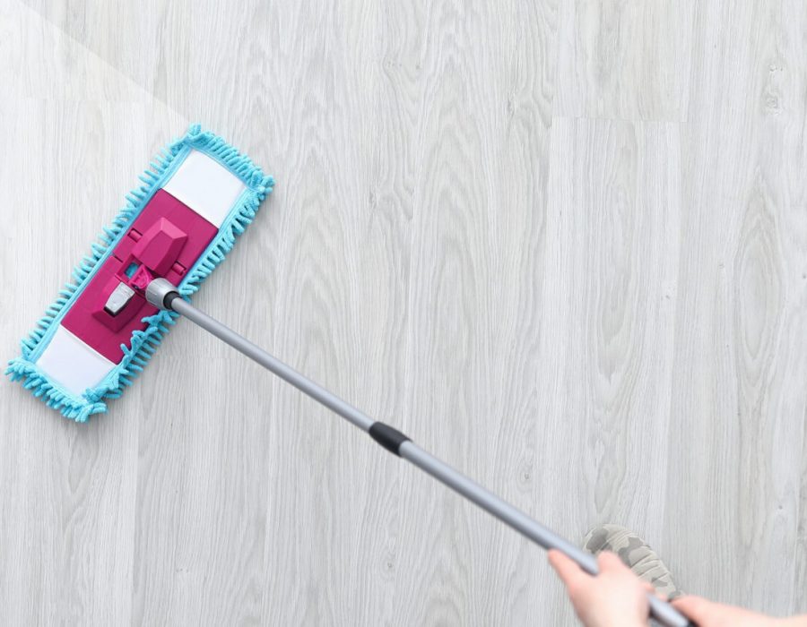 Male hant hold plastic mop and wash dirty ploor closeup background. Professional cleaning concept